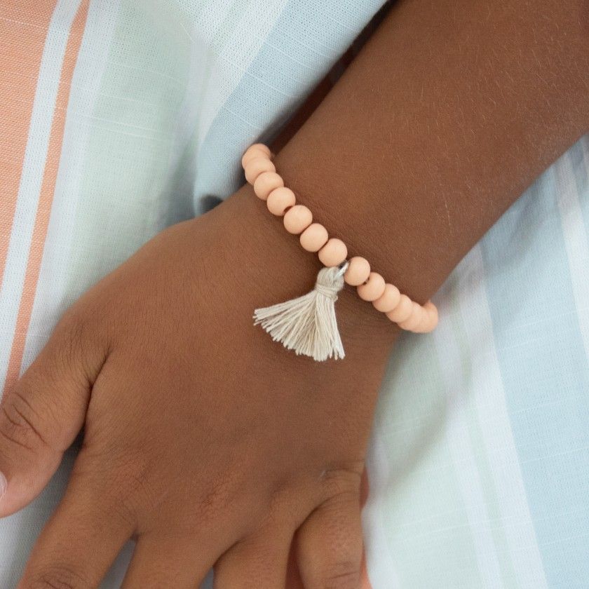 Elastic bracelet with beads and pompom